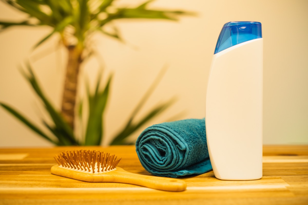 Shampoo, towel and a wooden hairbrush — caring for an itchy, flaky scalp